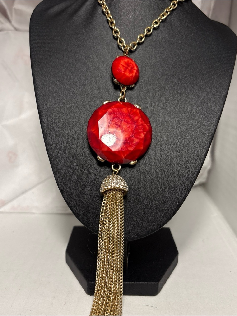 Gold-Tone Necklace with Red Faceted Pendant and Tassel Accent